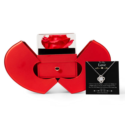 “Heart‑shaped red jewelry box with rose display, holding a silver heart necklace and message card.”